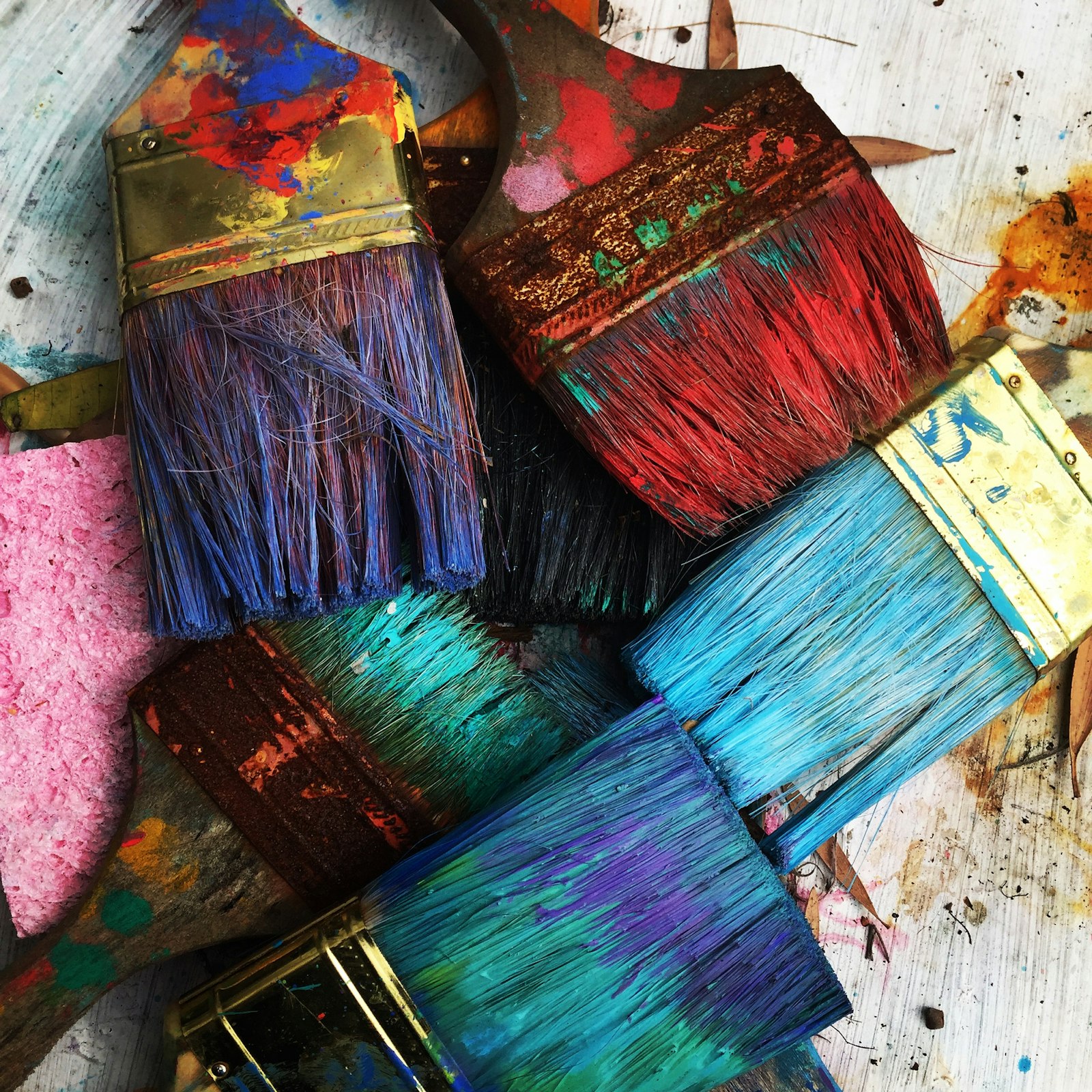 Senior painting on canvas during art therapy